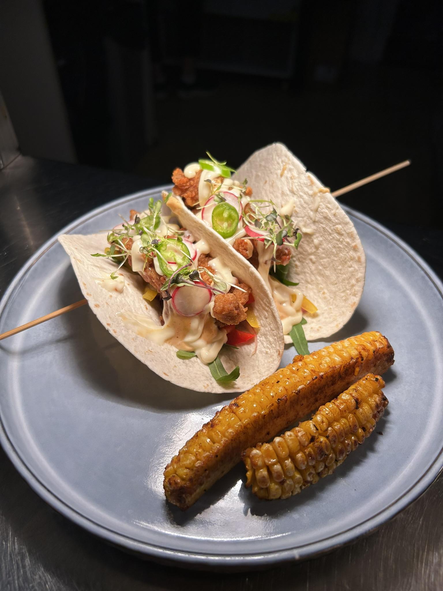 Tacos with grilled corn ribs, jalapeño, pickled radish and chipotle mayo